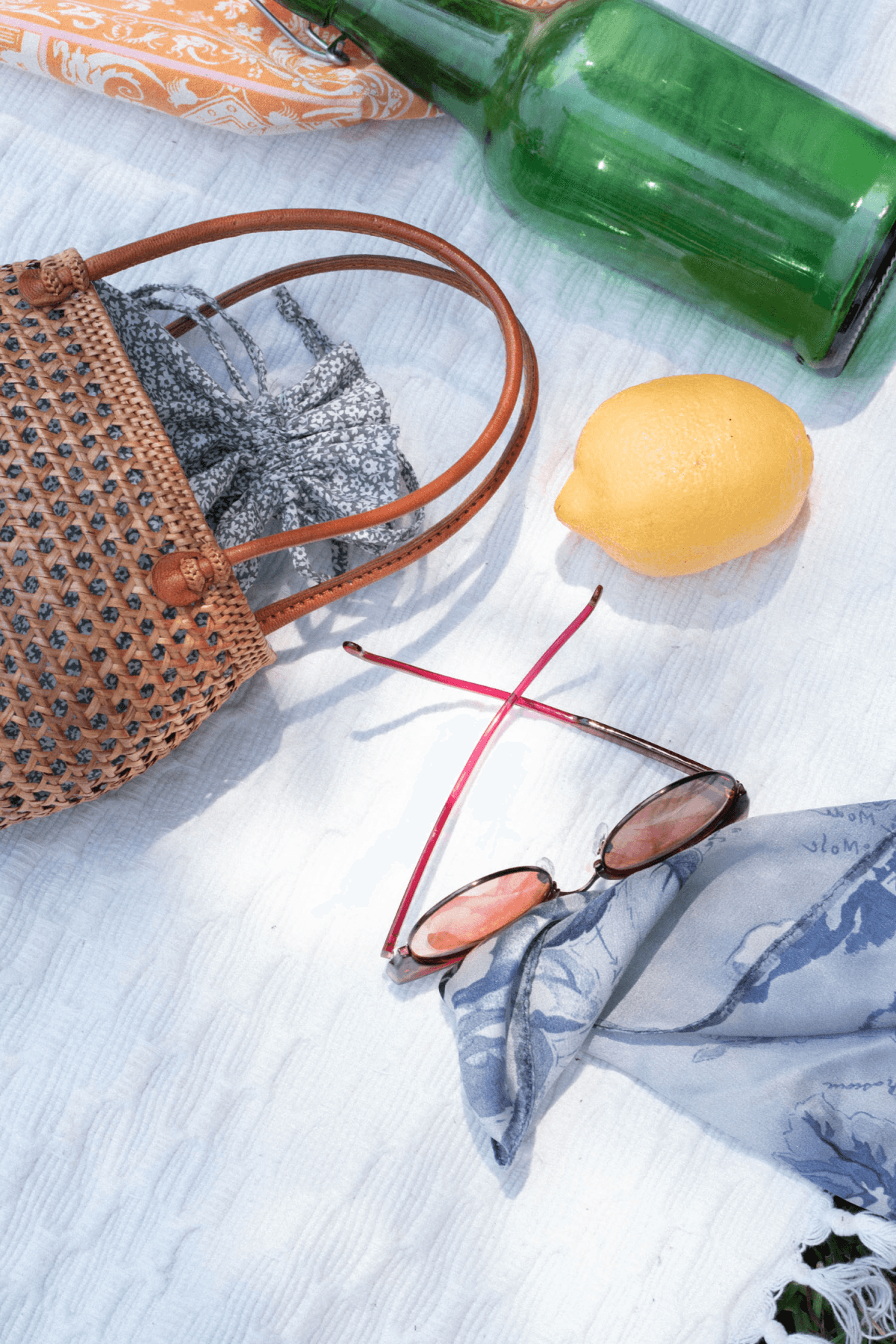 sunglasses and bag on blanket outdoors