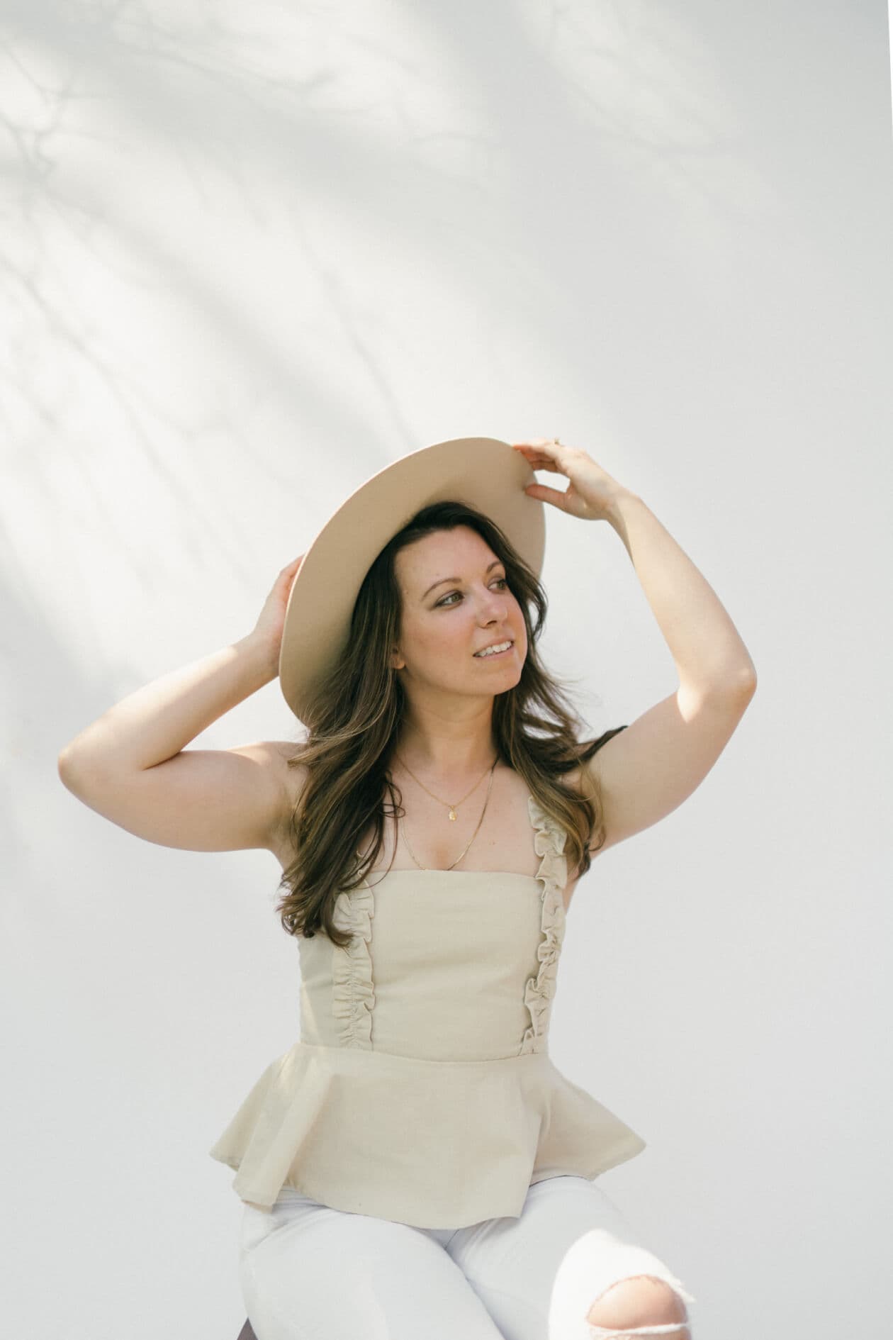 Emily wearing hat on white background