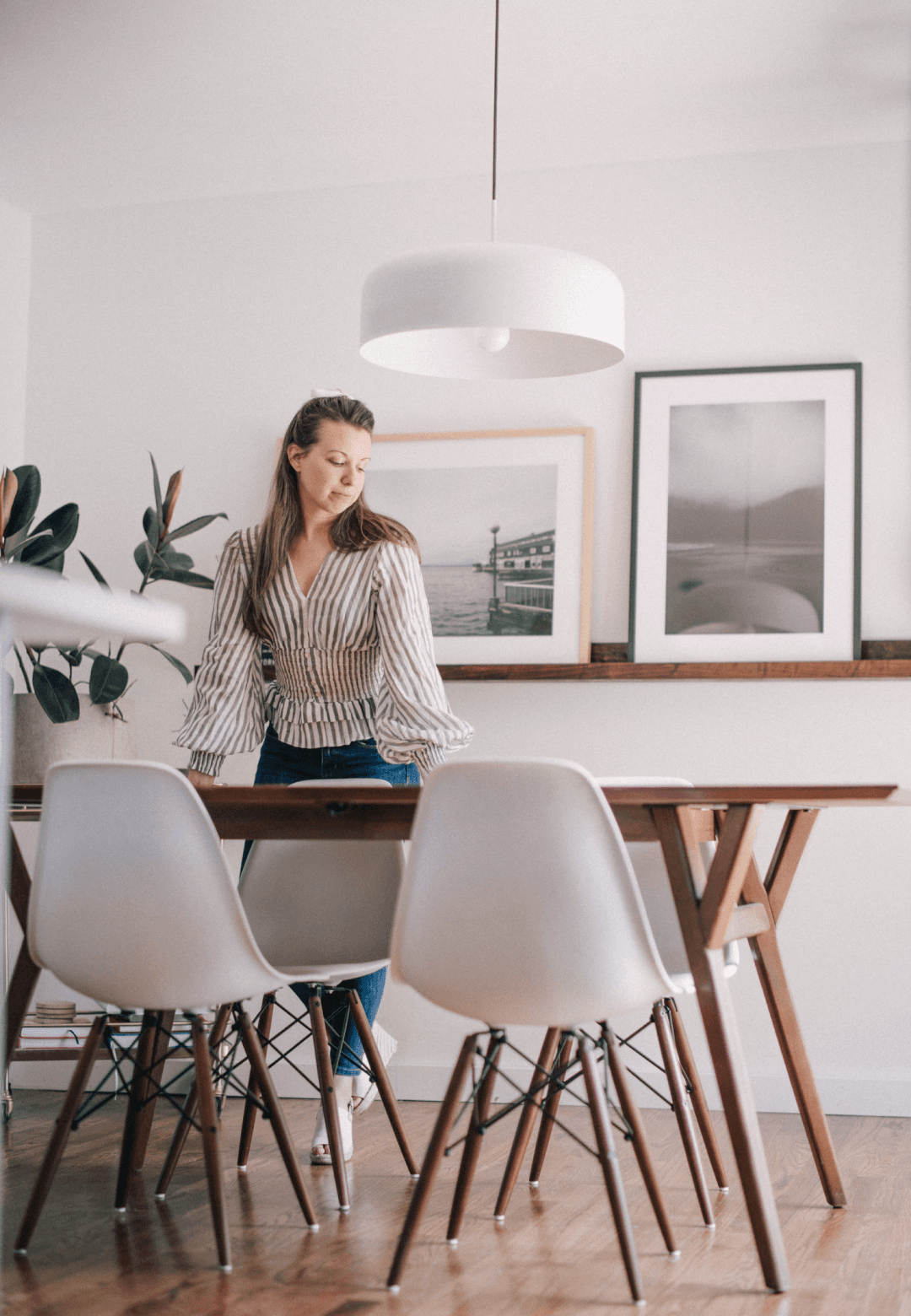 Emily standing at mid-century dining table