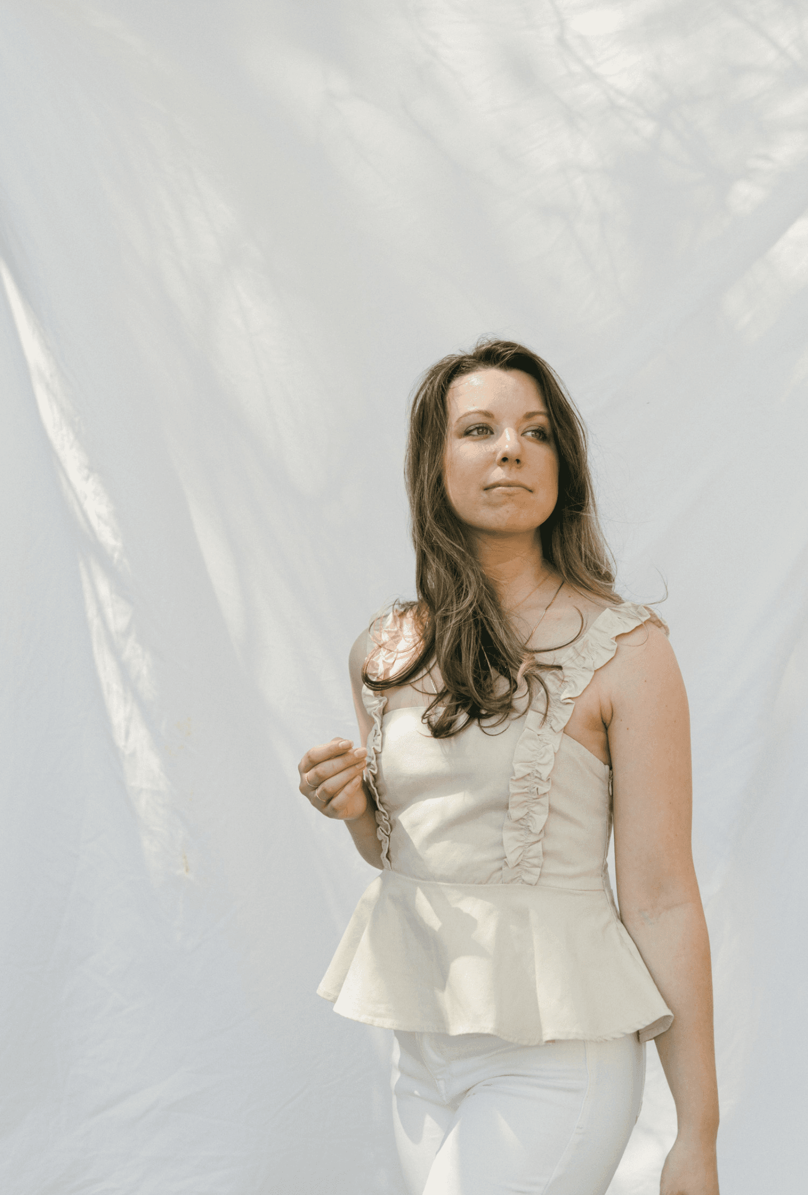 Emily in white top on fabric background